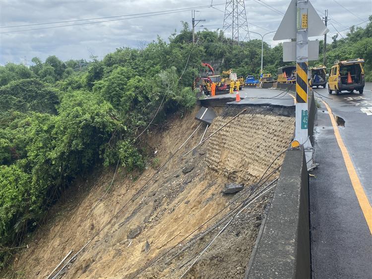 圖說：台南市龍崎區182縣道路基崩落，造成電桿流失至水溝，台電派員搶修。